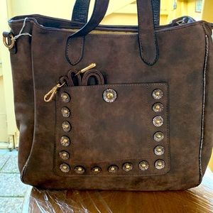 NEW Brown handbag. Man made material. It has two outside pockets, three inside
